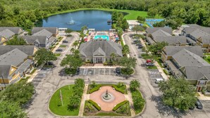 A residential area with a central swimming pool, a fountain, and a landscaped courtyard. - Cozy Kissimmee Getaway Near Orlando Attractions (Kissimmee)