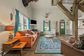 A cozy living room with a sofa, a coffee table, and a fireplace. - Hildy's Hideaway | NEW! Sleeps 10 | Direct Snowmobile Access | Near Saddleback & Downtown (Rangeley)