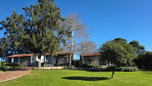 A residential property with a paved driveway, two-story houses, and a well-maintained lawn.