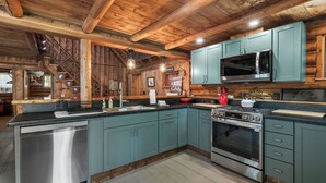 A kitchen with a stainless steel dishwasher, a microwave, and an oven. - The Boston | Waterfront on Mooselookmegtunic Lake | Pet Friendly (Rangeley)