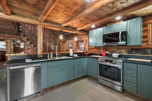 A kitchen with a stainless steel dishwasher, a microwave, and an oven. - The Boston | Waterfront on Mooselookmegtunic Lake | Pet Friendly (Rangeley)