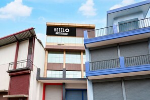 A hotel building with a sign that reads 'HOTEL' and 'YOY-Serviced'. - Deluxe Room North Star Residency (Dehradun)