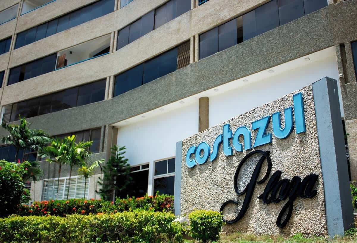 A hotel sign with the name 'Costazul Playa' against a building facade.