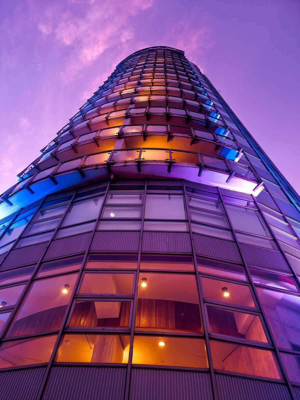 A high-rise building with a curved facade and multiple windows.