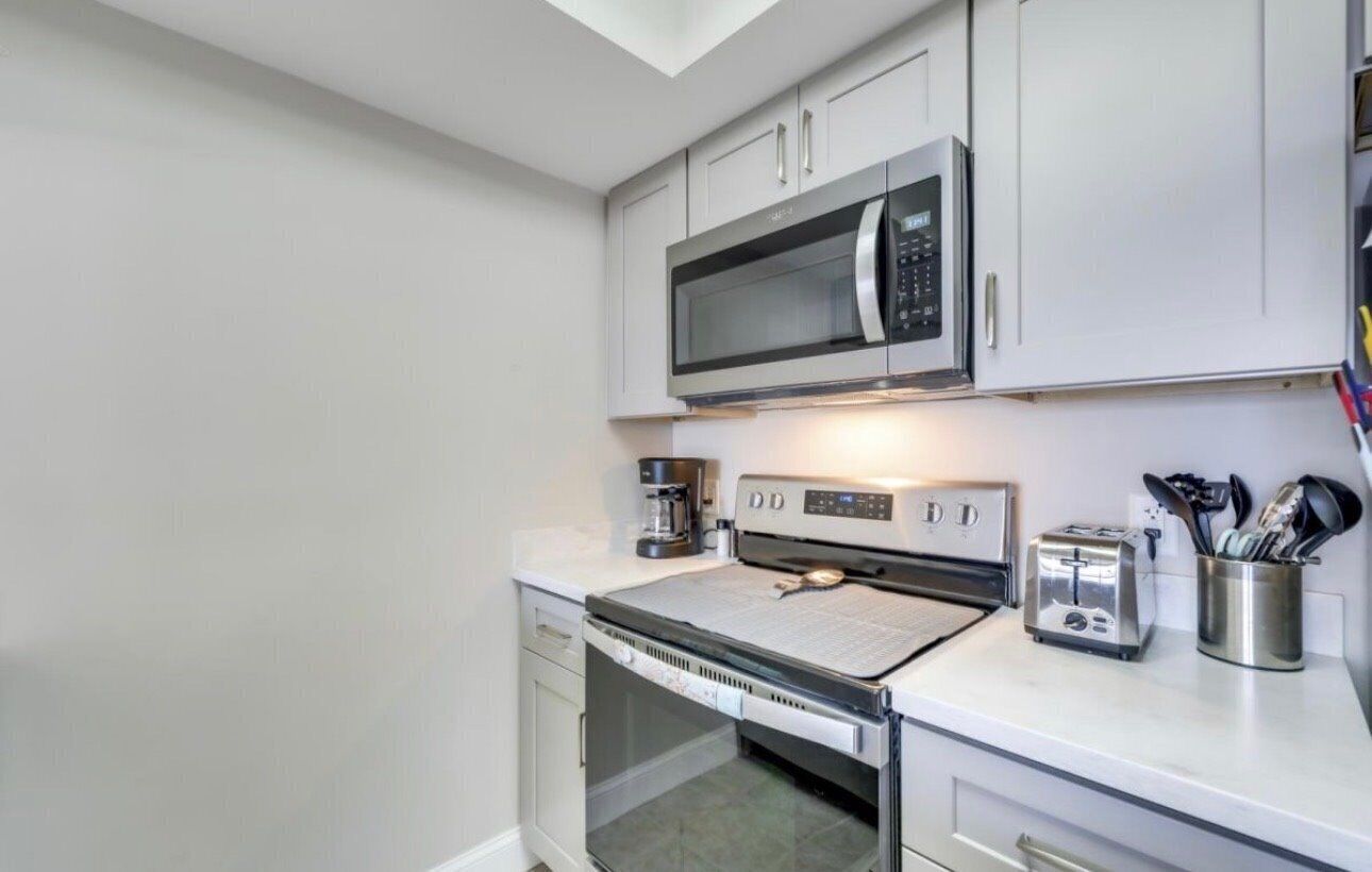 A compact kitchen with a microwave, toaster, and coffee maker.