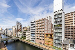 A multi-story residential building with a river running alongside. - 2nd Floor / Shinsaibashi River View / Near Dotonbori, Kuromon Market, and Nipponbashi Station (Osaka City)