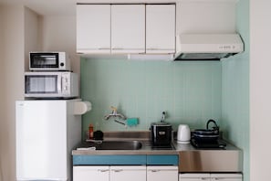 A compact kitchen with a microwave, toaster, and a kettle on the countertop. - 2nd Floor / Shinsaibashi River View / Near Dotonbori, Kuromon Market, and Nipponbashi Station (Osaka City)