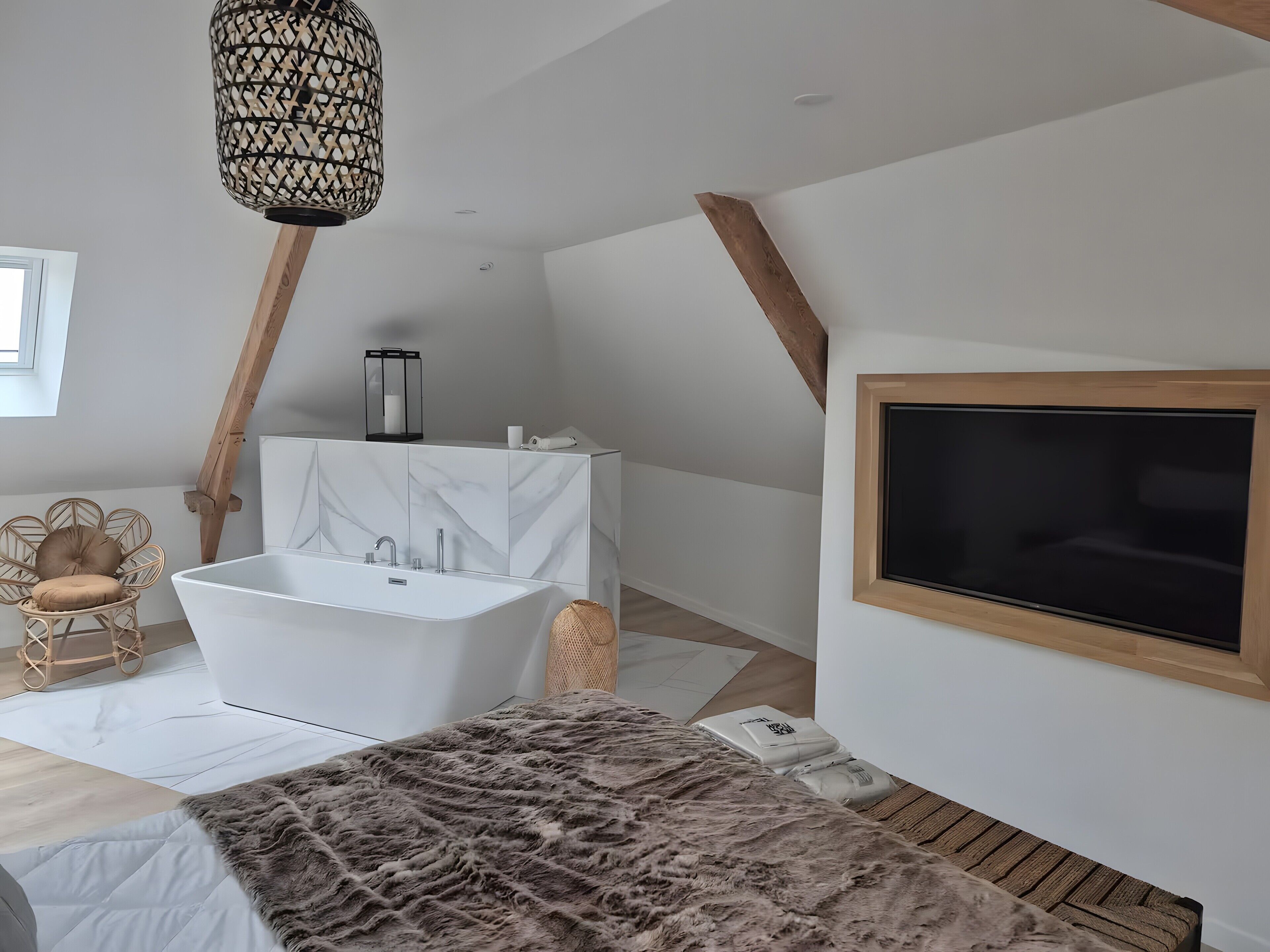 A modern bathroom with a freestanding bathtub, a large mirror, and a wooden ceiling beam.