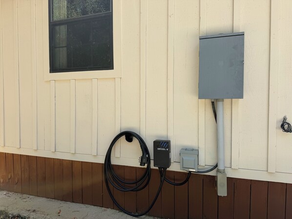 A utility box mounted on a wall with a window above it.