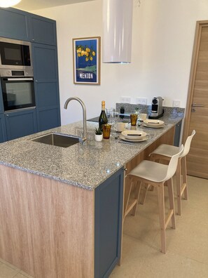 A kitchen with a granite countertop, a built-in oven, a sink, and a coffee maker. - Villa central Cannes-4BR/3BA/8P-AC-free parking-12’ walk to Palais des Festival (Cannes)