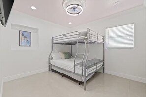 A bunk bed in a room with white walls, a ceiling light, and a window with blinds. - Gorgeous Home/Heated Pool/Clearwater/Tampa/Disney (Tampa)
