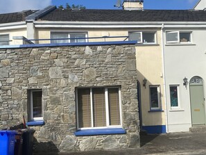 A two-story building with a stone facade and a flat roof. - 6 Riverfalls Clifden (Clifden)