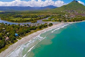 A coastal landscape with a river, beach, and residential area. - 17 Ocean Legend (Tamarin)