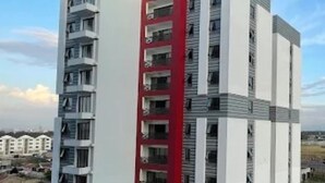 A multi-story residential building with a distinctive red vertical section. - The Enkang Urban Escape (Nairobi)