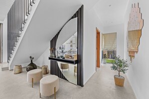 A modern interior with a staircase, a console table, and a potted plant. - Villa Kim (Buje)
