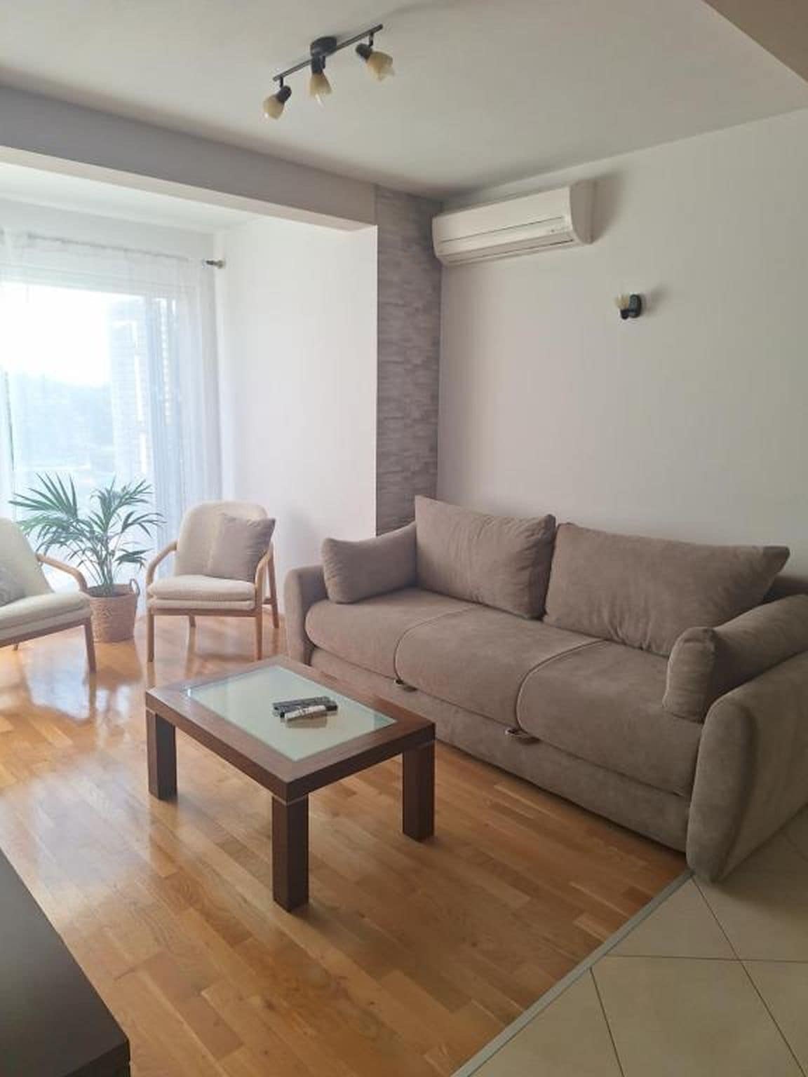 Un salon avec un canapé, un fauteuil et une table basse.