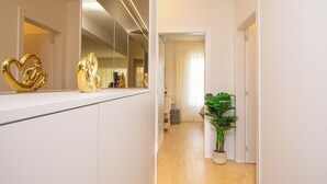A hallway with a large mirror, a potted plant, and a door leading to another room. - House Nadalina (Vrsi)