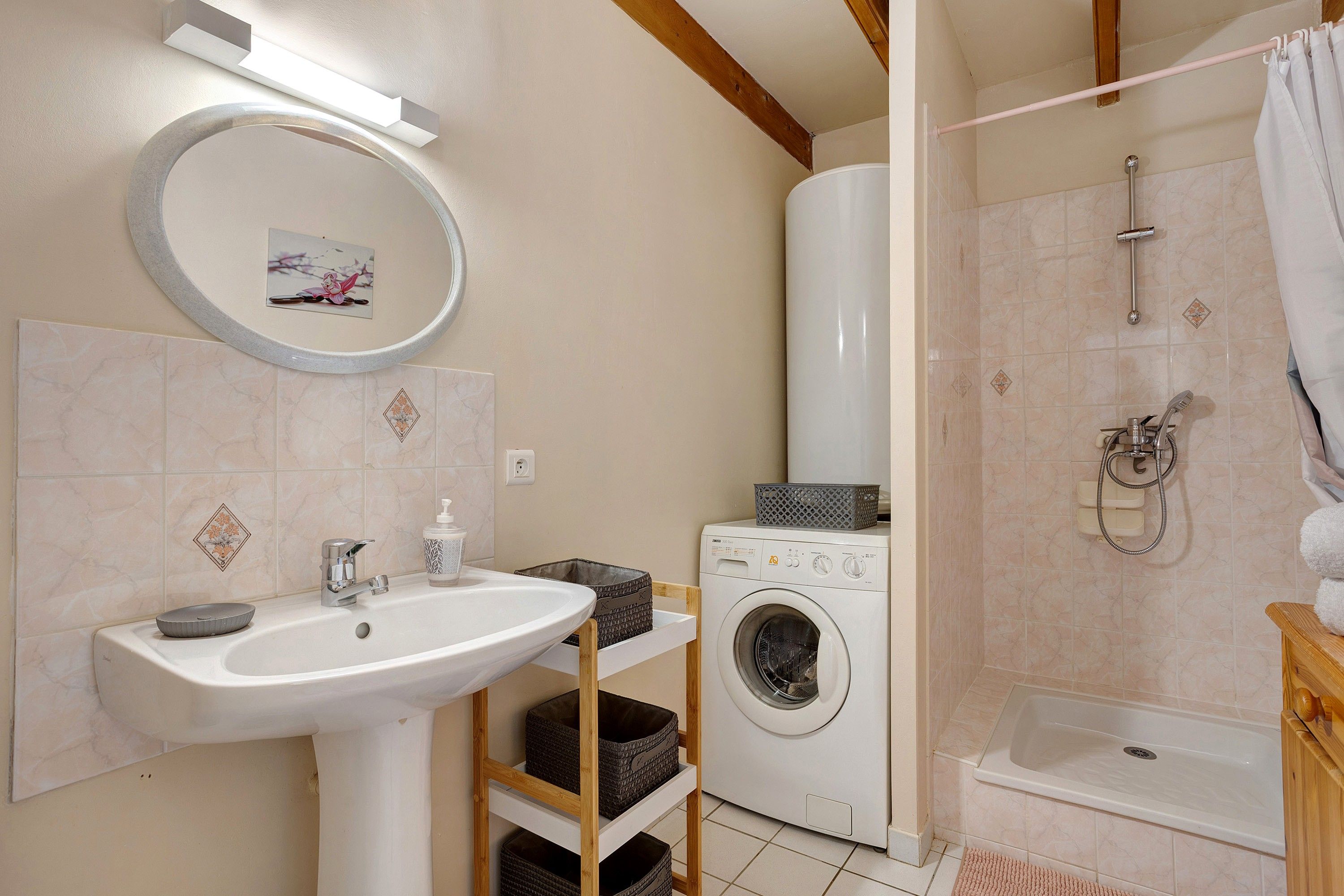 Ein Badezimmer mit Waschbecken, Waschmaschine, Dusche und Toilette.