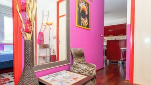 A vibrant room with a pink wall, a leopard print chair, a woven vase, and a framed picture. - Apartment Near City Center (Split)
