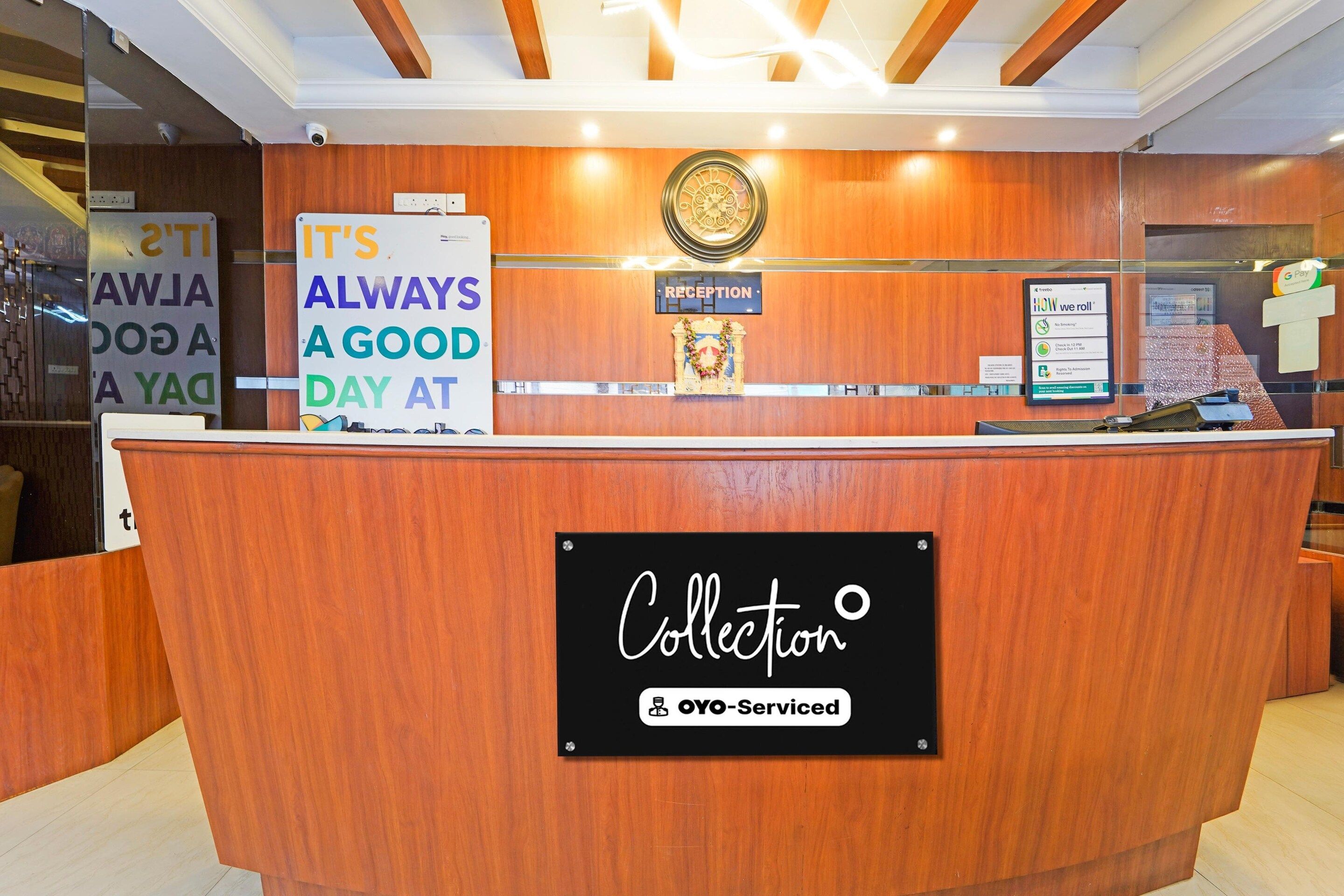 A reception desk with a sign that reads 'IT'S ALWAYS A GOOD DAY AT Collection OYO-Serviced.'