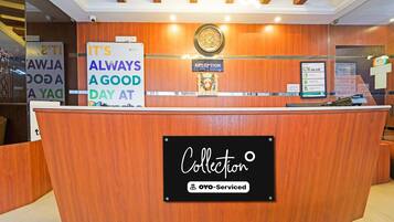 A reception desk with a sign that reads 'IT'S ALWAYS A GOOD DAY AT Collection OYO-Serviced.'
