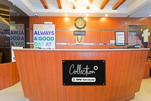 A reception desk with a sign that reads 'IT'S ALWAYS A GOOD DAY AT Collection OYO-Serviced.'