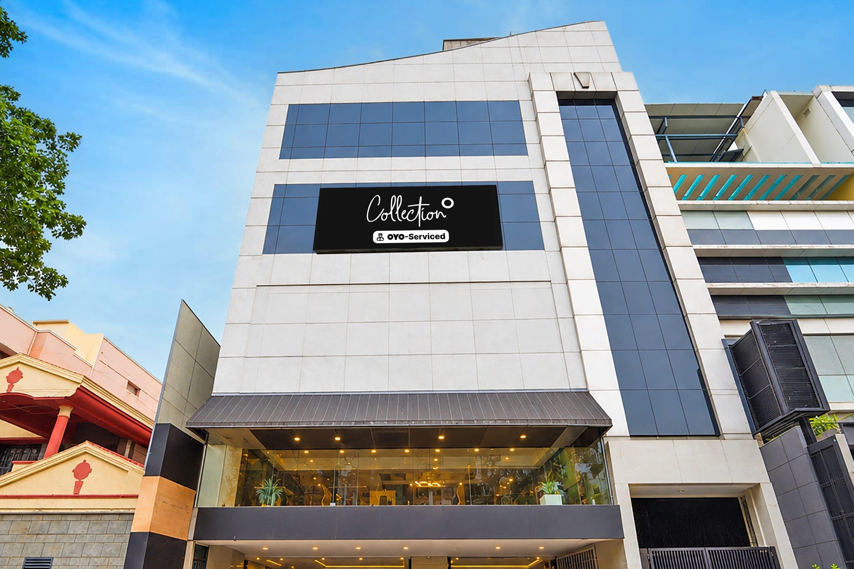 A modern building with a sign that reads 'Collection' and 'OYO-Serviced'.