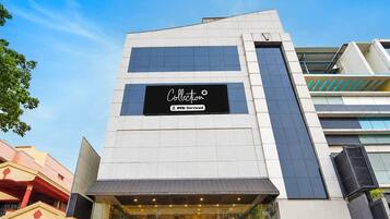 A modern building with a sign that reads 'Collection' and 'OYO-Serviced'.