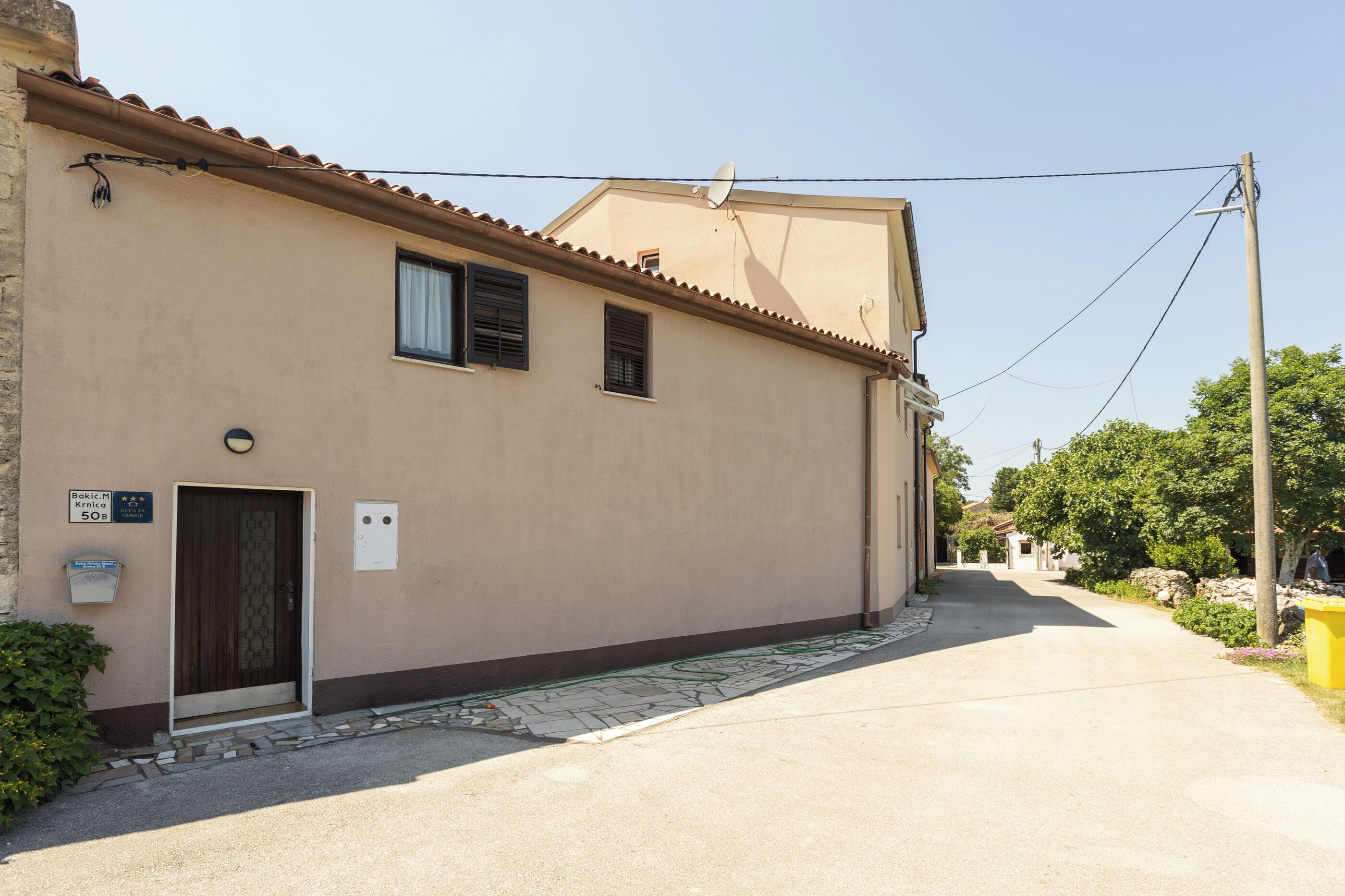 A building with a door, windows, and a satellite dish.