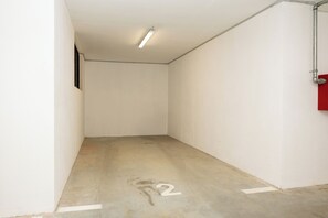 A narrow hallway with white walls, a concrete floor, and a number '2' marking. - Apartment Seaview Terrace (Podstrana)