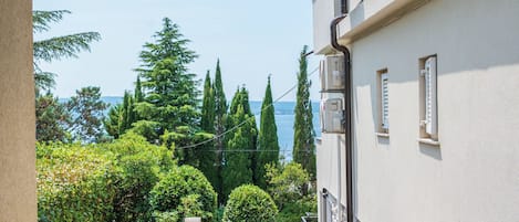 A building with a view of a body of water, surrounded by trees.
