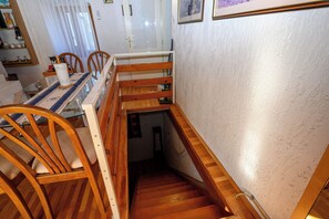 A wooden staircase with a handrail leading to a lower level. - House Arija (Novi Vinodolski)