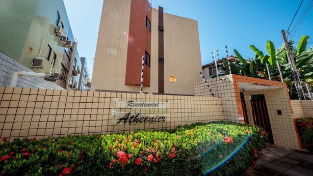A residential building with a tiled facade, a central vertical feature, and a sign reading 'Residencial Athenier.' - Apto c 3 Quartos e Garagem a 260 m da Praia (João Pessoa)