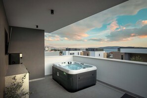 A hot tub on a balcony with a cityscape view. - Villa Respiro Residence North (Kastela)