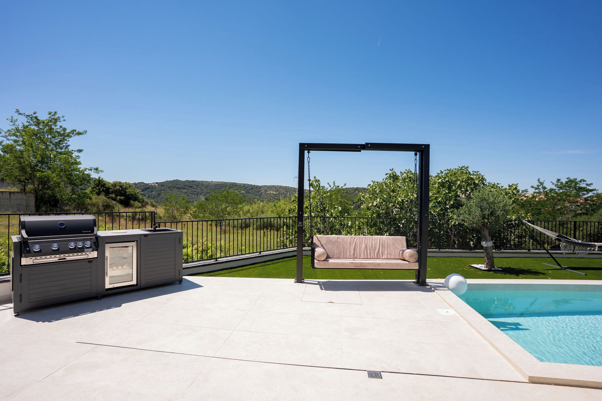 Outdoor pool, a heated pool, open open 24 hours a day, pool umbrellas