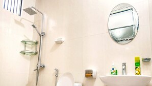 A modern bathroom with a glass shower enclosure, a toilet, a sink, and a mirror. - Private 2-bedroom Beachfront Apartment in Uroa, Zanzibar (Uroa)