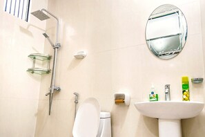 A modern bathroom with a glass shower enclosure, a toilet, a sink, and a mirror. - Private 2-bedroom Beachfront Apartment in Uroa, Zanzibar (Uroa)