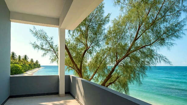 A balcony with a view of the sea and palm trees. - Private 2-bedroom Beachfront Apartment in Uroa, Zanzibar (Uroa)