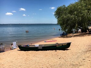 A beach with a rowboat labeled 'WILLOW POINT' and a beach chair.