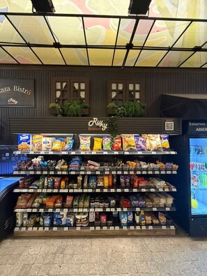 A snack display with various packaged foods and a refrigerated section. - Cozy 1 Bedroom in Santiago in Somma Asturias (Santiago)