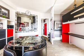 A modern kitchen with a central island, a red refrigerator, and a clock on the wall. - Algarrobo Beach 7, Algarrobo Costa (Algarrobo Costa)