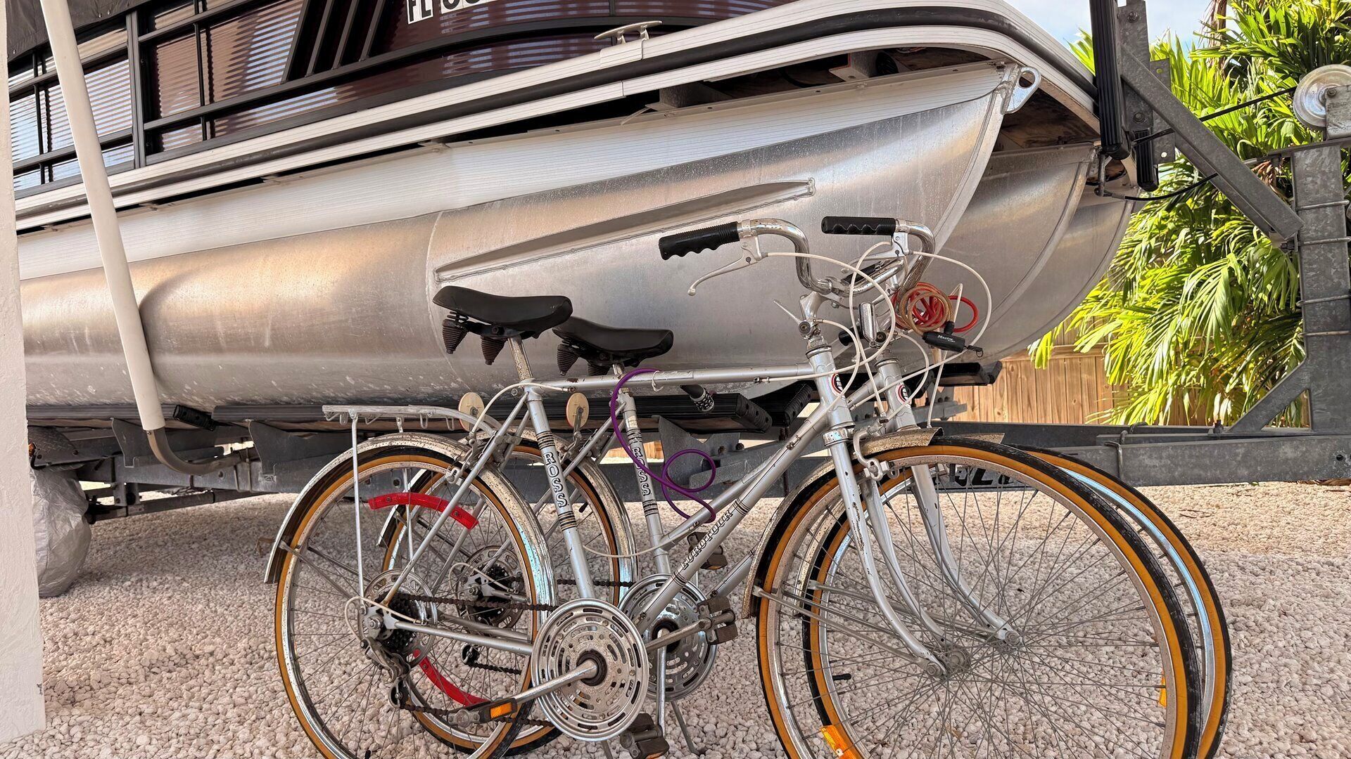 A bicycle parked in front of a boat.