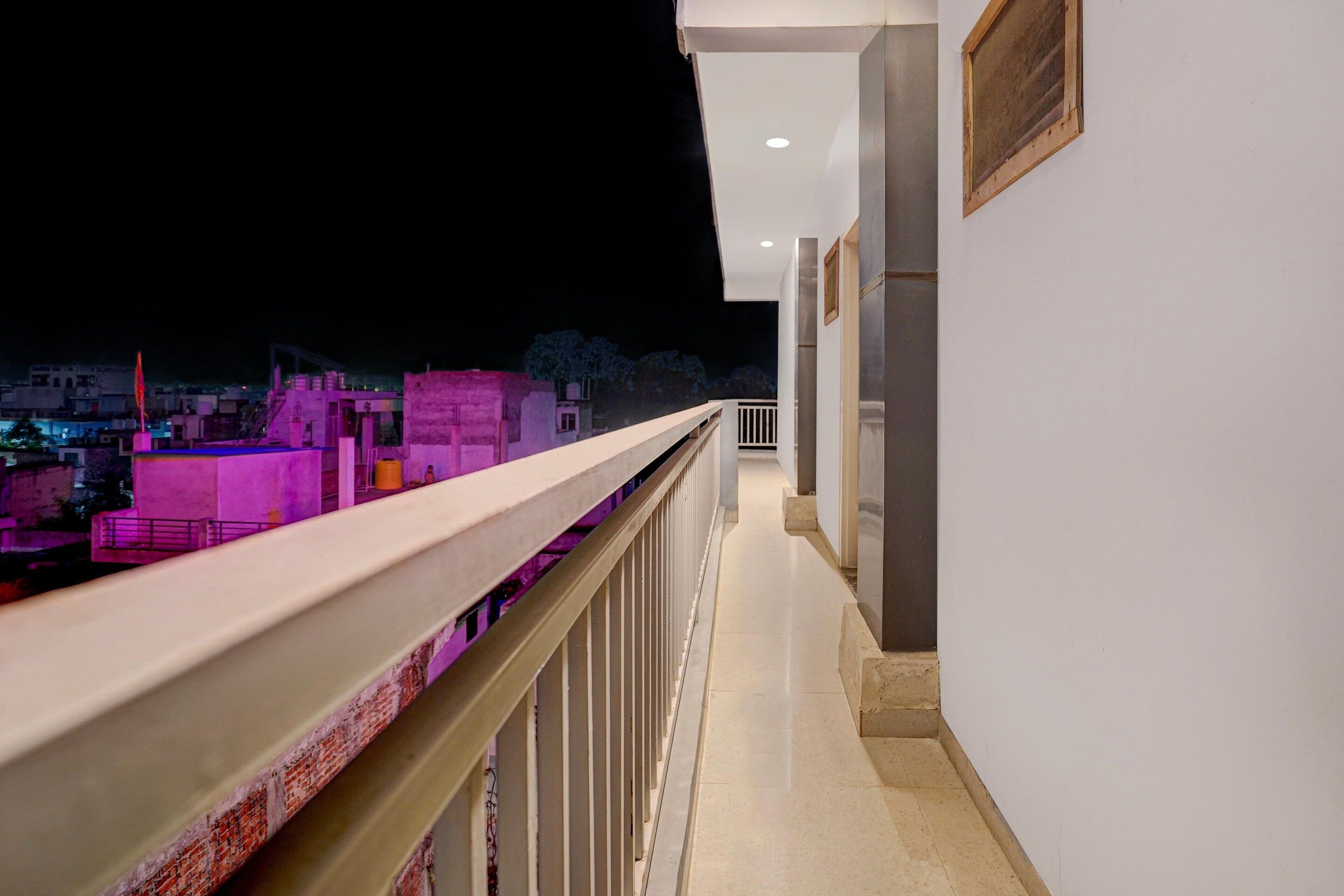 A balcony with a view of buildings at night.