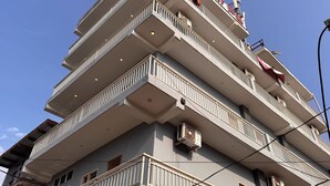 A multi-story building with balconies, air conditioning units, and a clear sky. - Ollection O Sector 95B Gurgaon (Gurugram)
