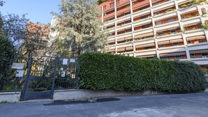 A multi-story residential building with balconies, a gated entrance, and a well-maintained hedge. - Lodi, 65 – Your Milan Base (Milan)