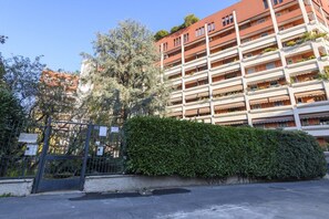 A multi-story residential building with balconies, a gated entrance, and a well-maintained hedge. - Lodi, 65 – Your Milan Base (Milan)