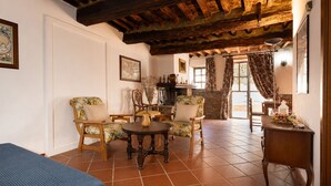 A traditional room with a tiled floor, wooden furniture, and a rustic ceiling. - Gaetano Spadaro Estate, Leccino Apartment (Capannori)