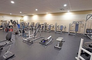 A gym with various exercise machines and free weights. - Mountain Melody- Cozy 3-bedroom cabin with AC in Ellijay- Hot Tub + EV Charger (Ellijay)