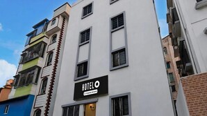 A multi-story hotel building with a prominent 'HOTEL' sign on the facade. - Deluxe Hotel Bidisha (Kanthi)