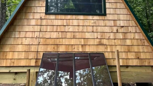 A wooden cabin with a triangular roof, a window, and a door with a window frame. - Scenic Off-Grid A-Frame with Private Fire Pit near White Mountain National Forest, Stoneham, Maine (Stoneham)